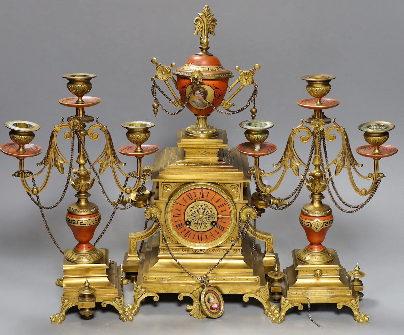 A late 19th century French Etruscan revival ormolu and porcelain mounted three piece clock garniture, 40cm